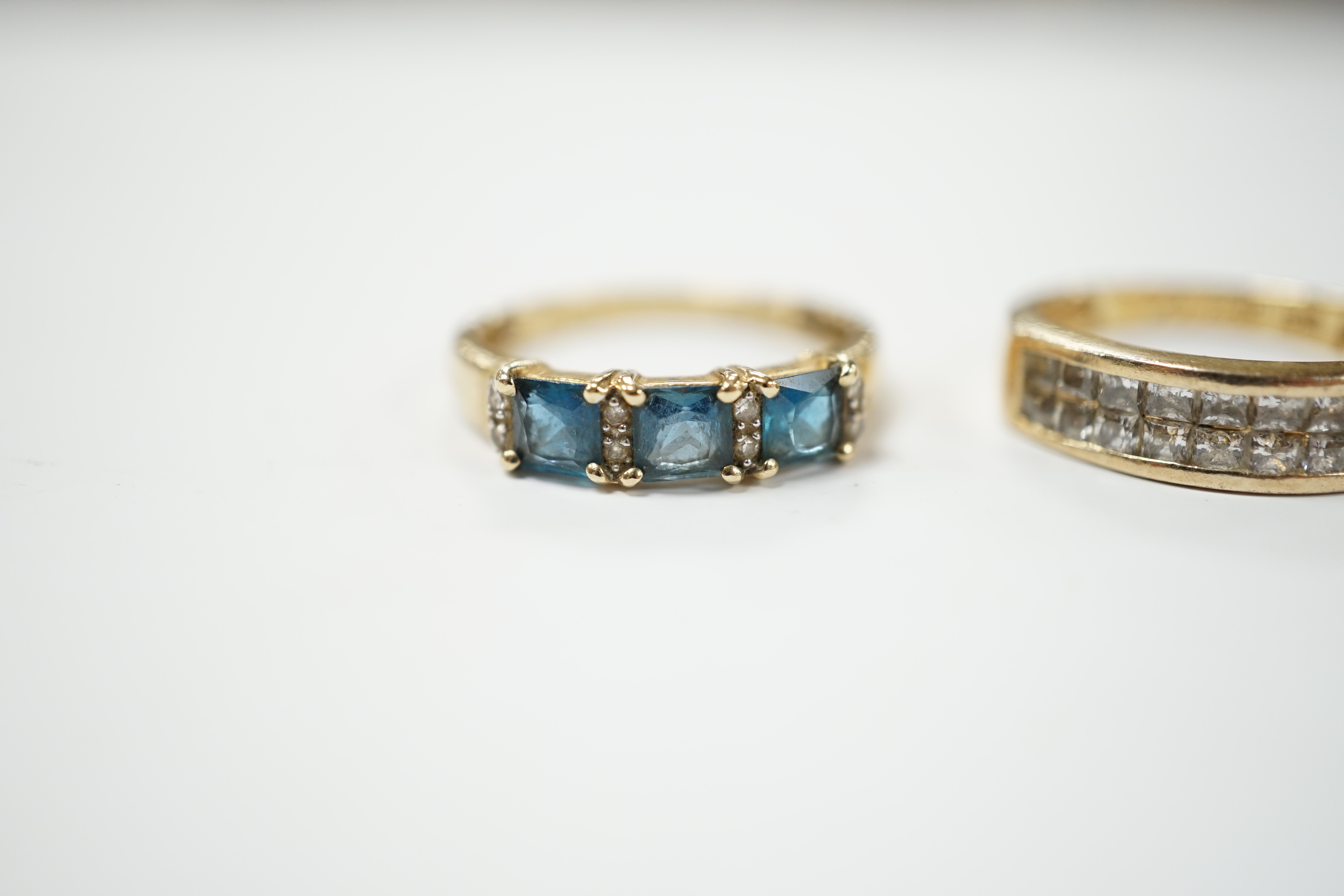 Two 9ct gold dress rings, one set with sapphire and diamonds, the other a single sapphire, and a diamond chip set ring, stamped 925, size M